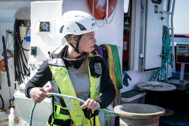 Employee holds a rope at a facility