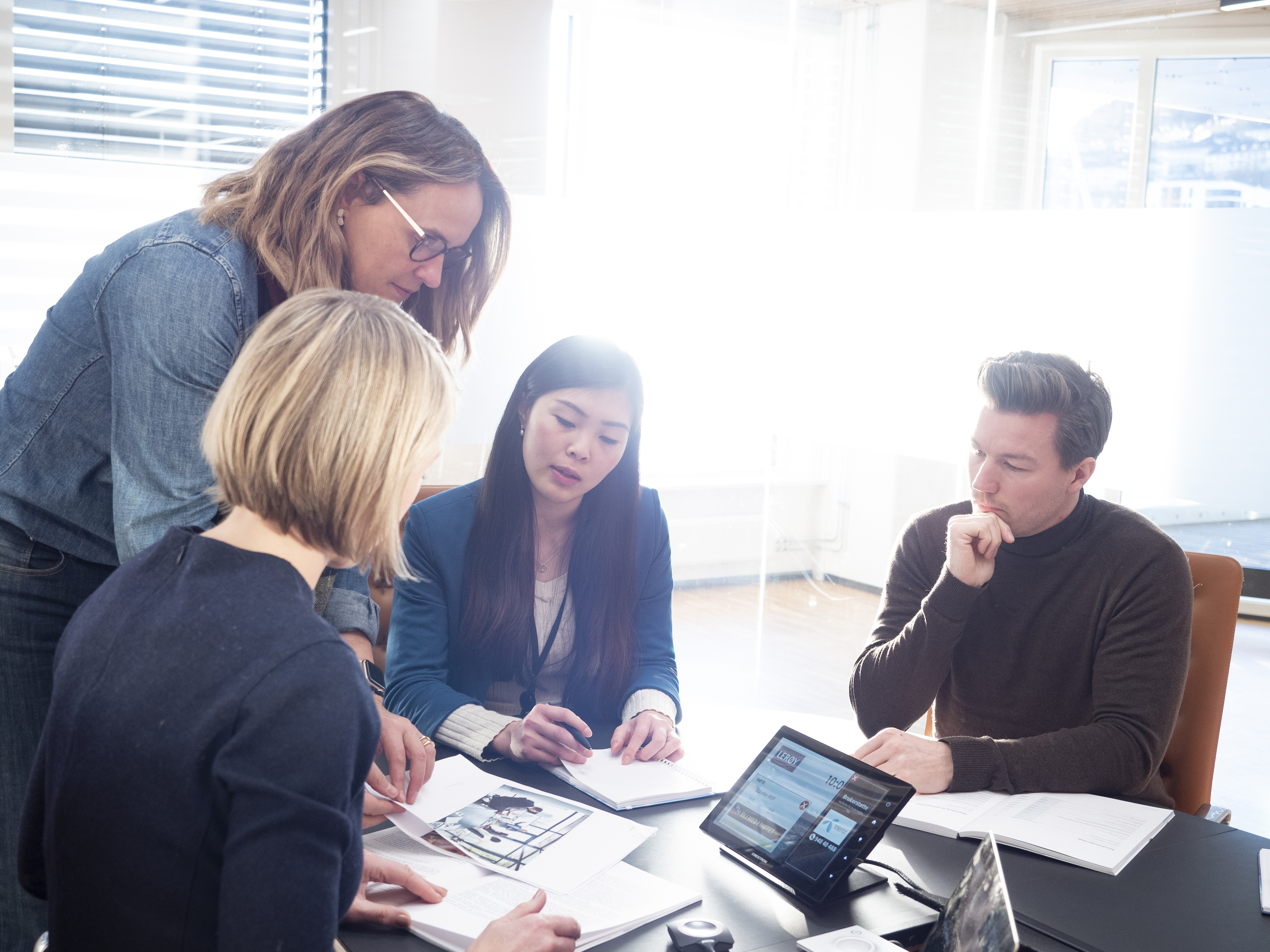 Office environment with people around a table