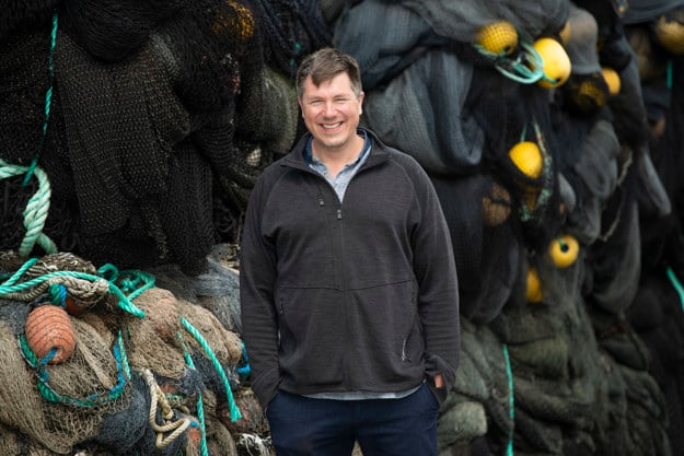 Man in front of old fishing gear